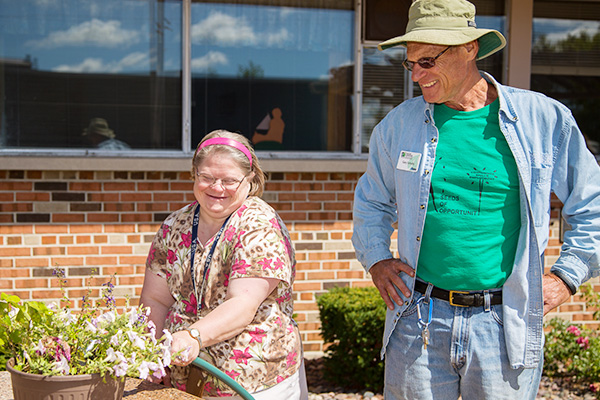 A master gardener working with a community memeber on a project