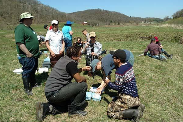 a group of water action volunteers setting up equipment