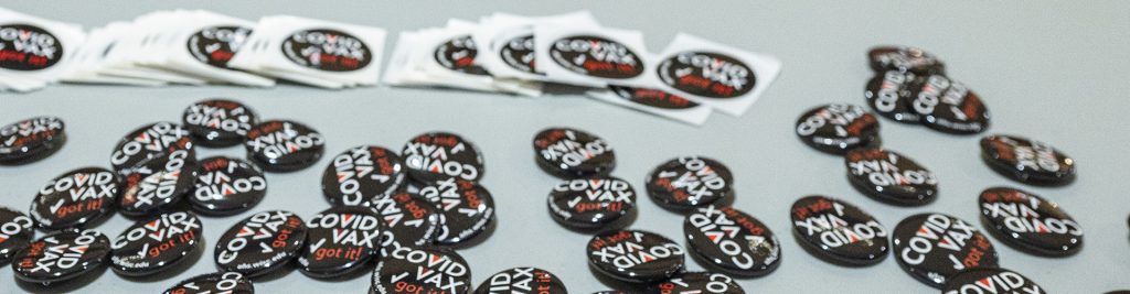 pins and stickers promoting getting vaccinated