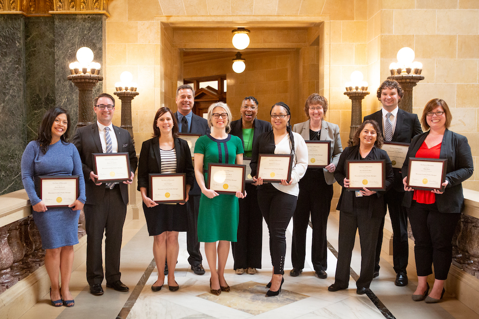 CPM graduating class poses for a photo with certificates