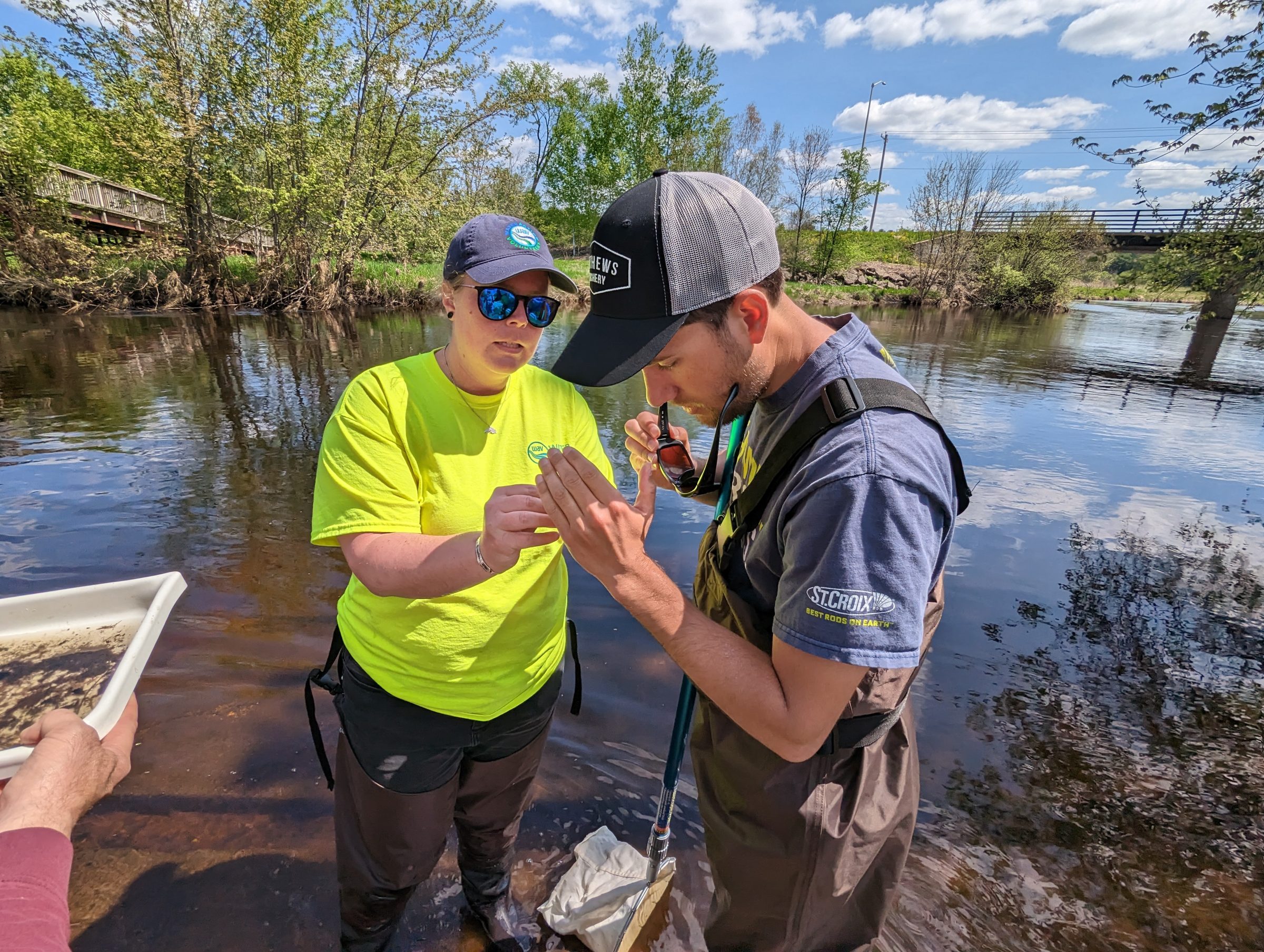 A Water Action Volunteer explaining something to another person